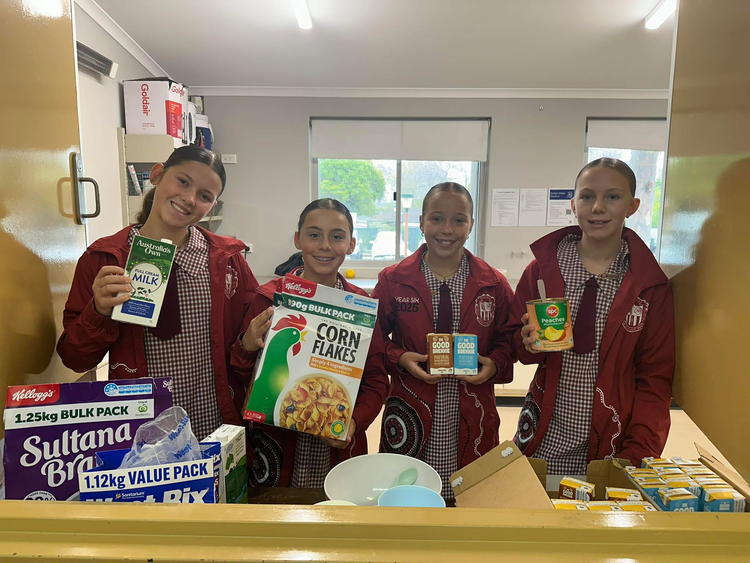 Students in our hall kitchen serving breakfast.