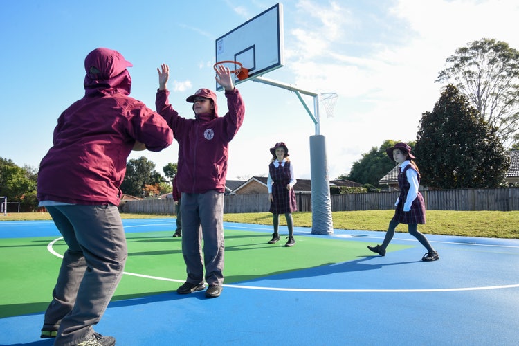 Students playing on the school basketball court