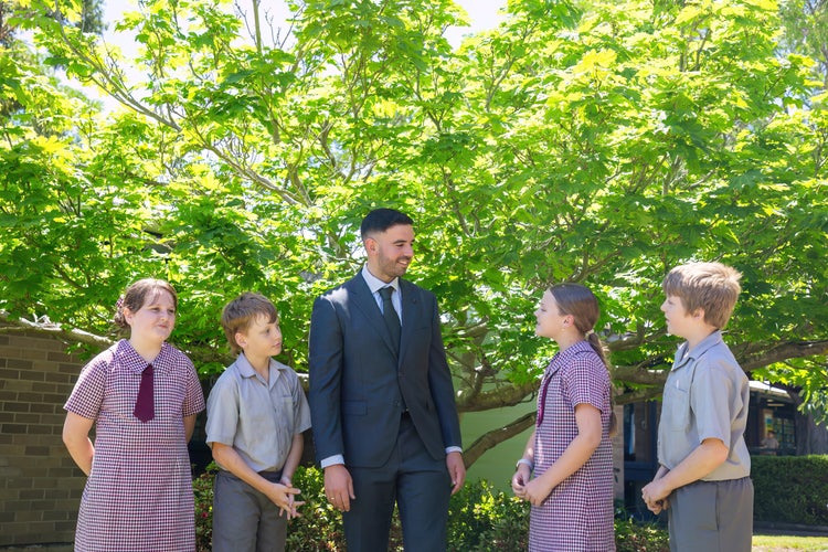 Student leaders and a teacher talking together