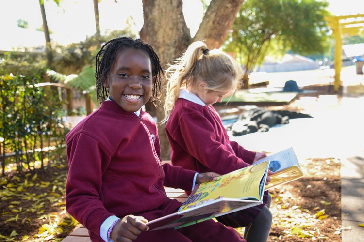 Two students reading books together