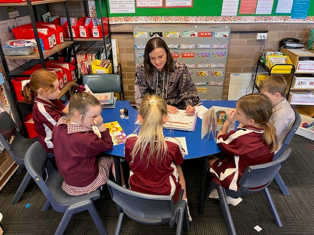 A teacher and a small group of students.