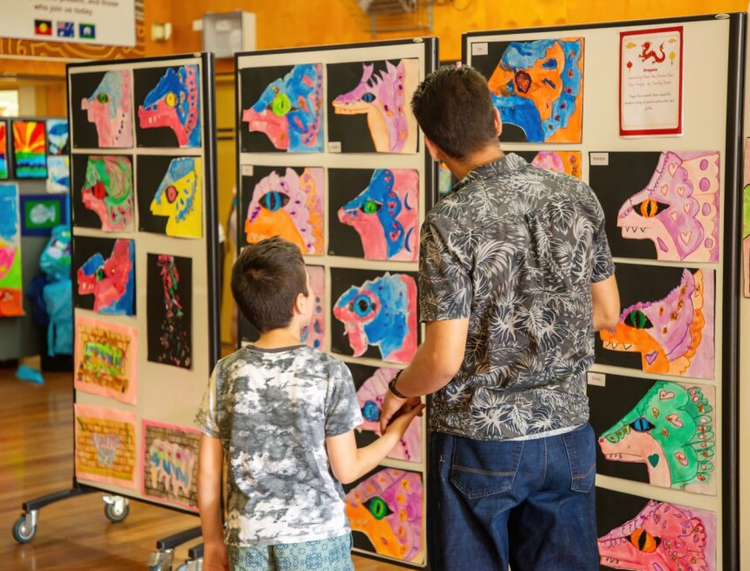 Father and son viewing the art at our school fete