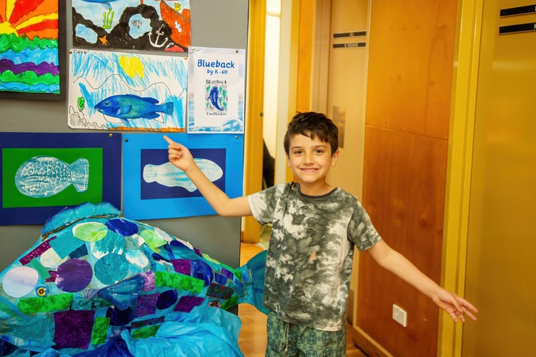 Student and artwork at our fete display